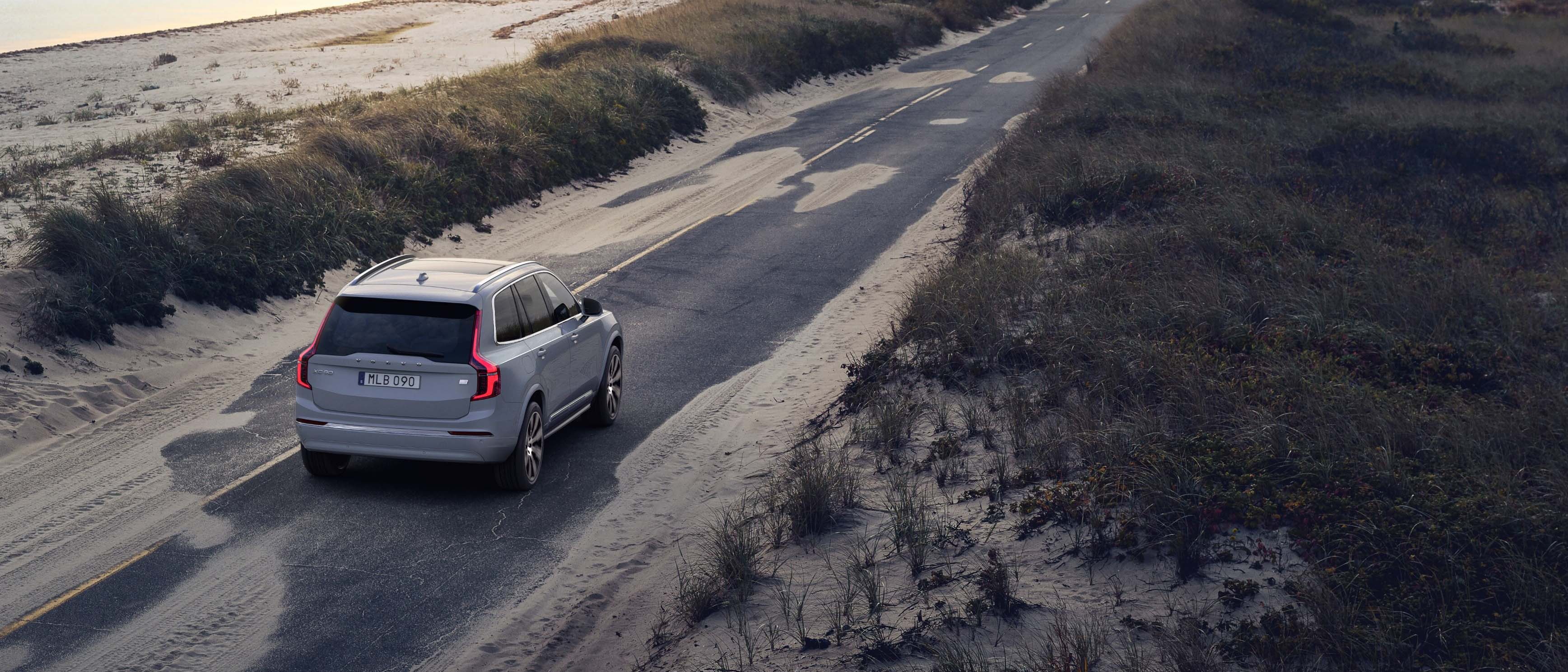 Volvo Summer Safely Savings Event - Volvo XC90 plug-in hybrid driving on road near beach