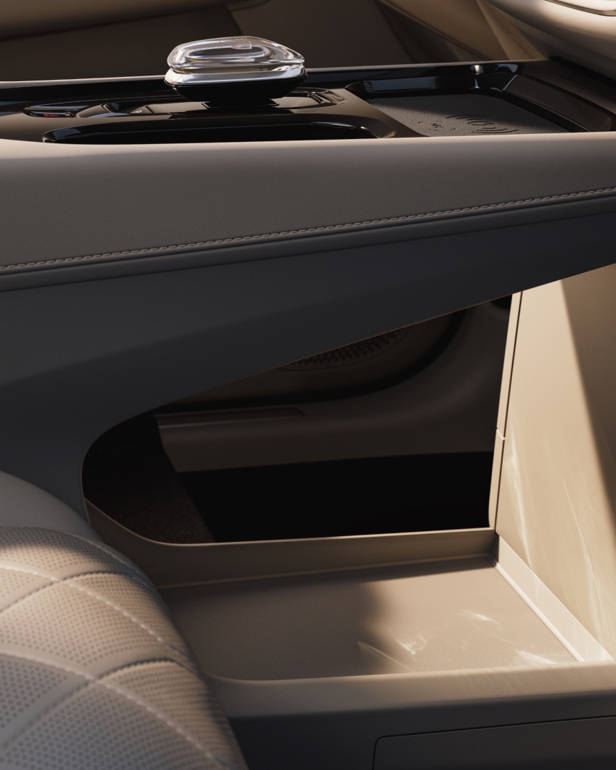 The spacious floor storage unit between the front seats of the Volvo EM90.