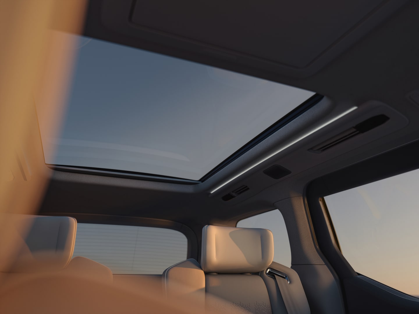 A clear blue sky viewed through the panoramic roof from inside the Volvo EM90 cabin.