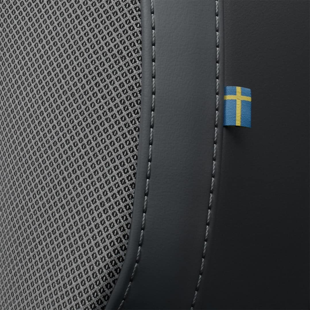 Close-up of the stitching on the Volvo S60 mild hybrid’s front passenger seat featuring a tiny Swedish flag. 