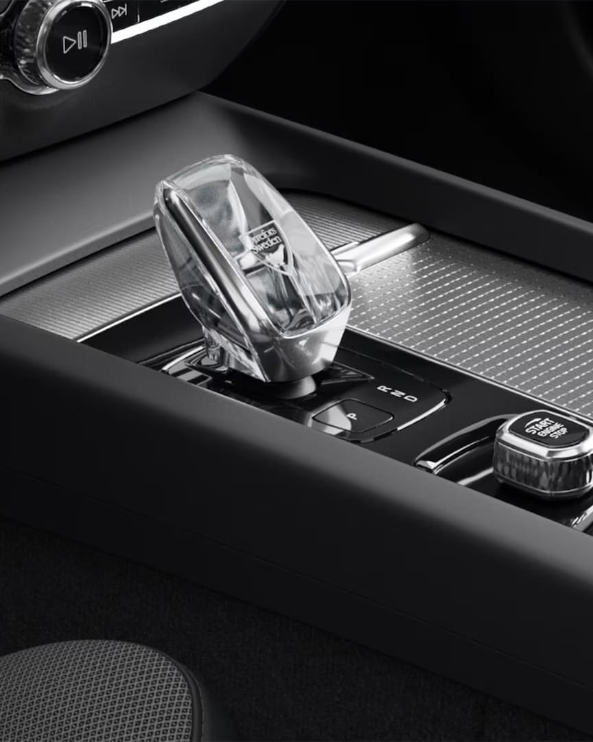 Start button and crystal gear shifter in the metal mesh-trimmed center console of the Volvo S60 mild hybrid.