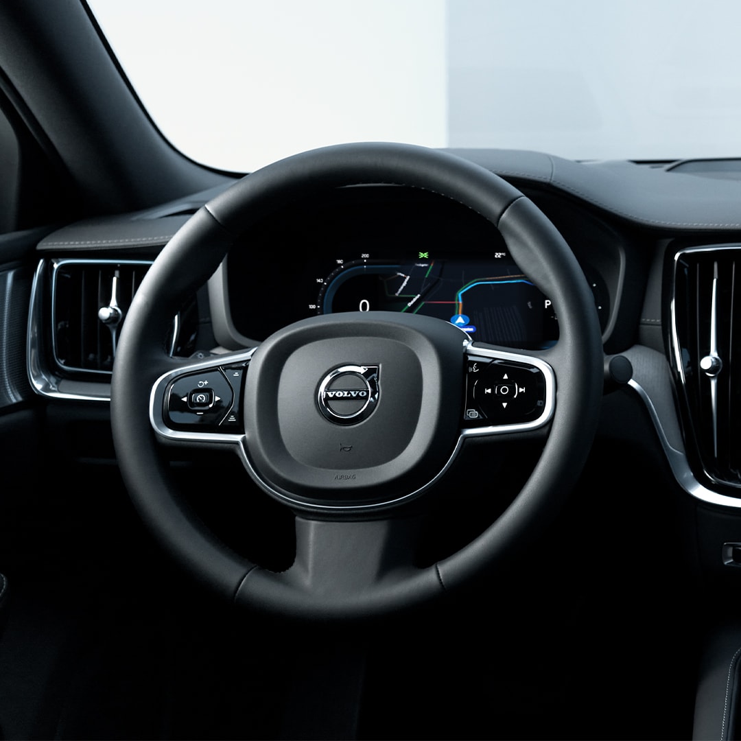 Driver’s view of the Volvo S60 Recharge plug-in hybrid’s steering wheel, instrument panel, vents and infotainment touchscreen. 