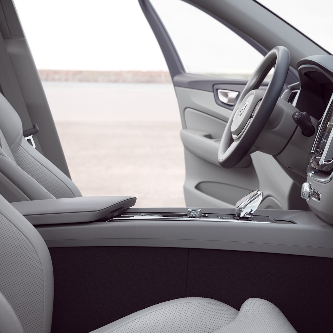 Front interior of Volvo XC60 with driver door open.