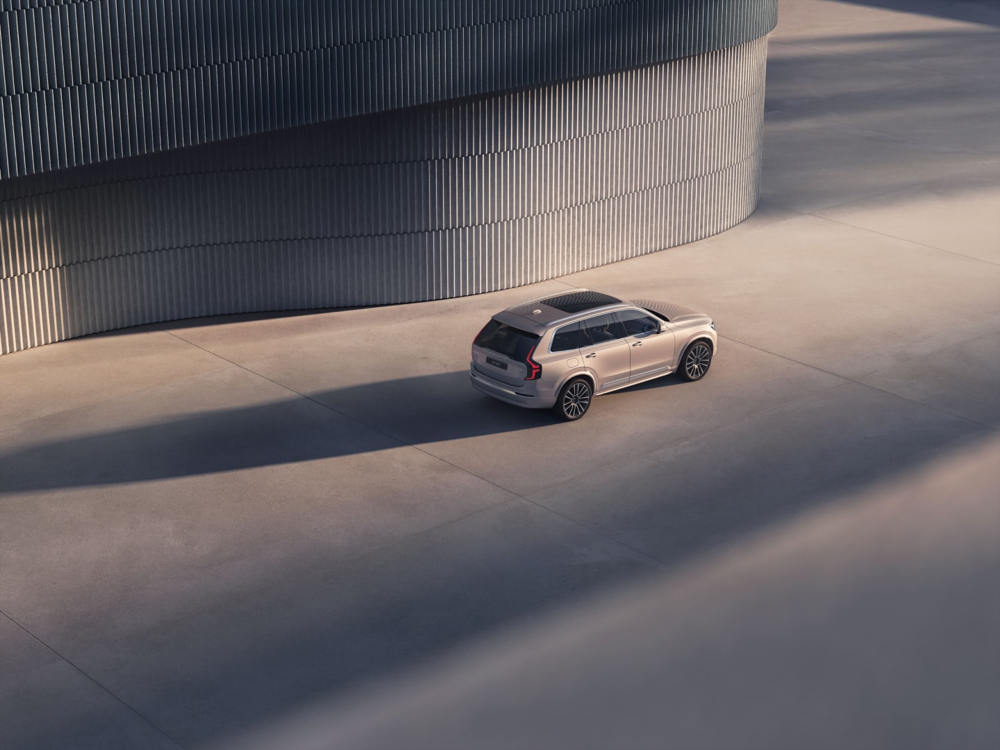 A 3/4 angle aerial shot of the XC90 plug-in hybrid SUV.