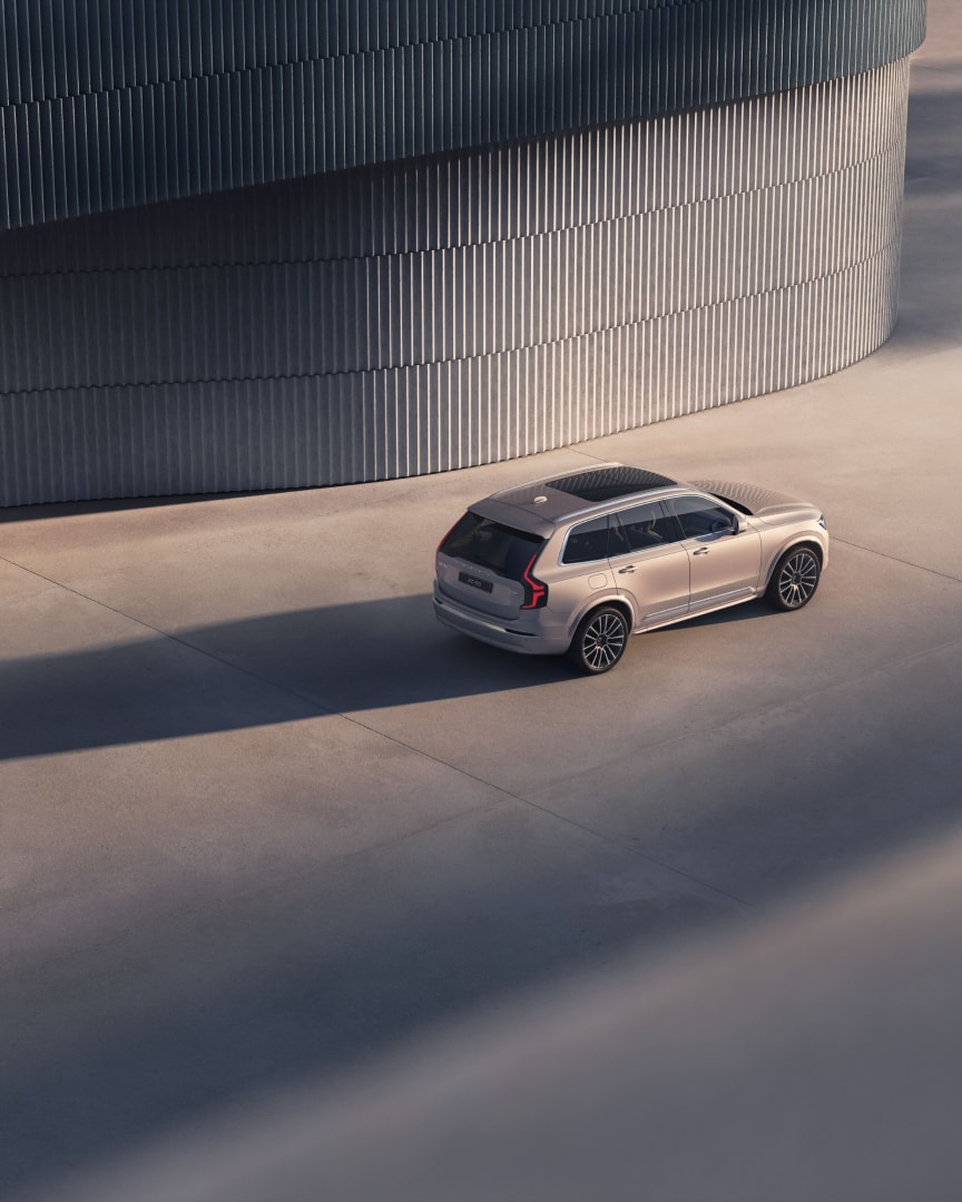 A 3/4 angle aerial shot of the XC90 plug-in hybrid SUV.