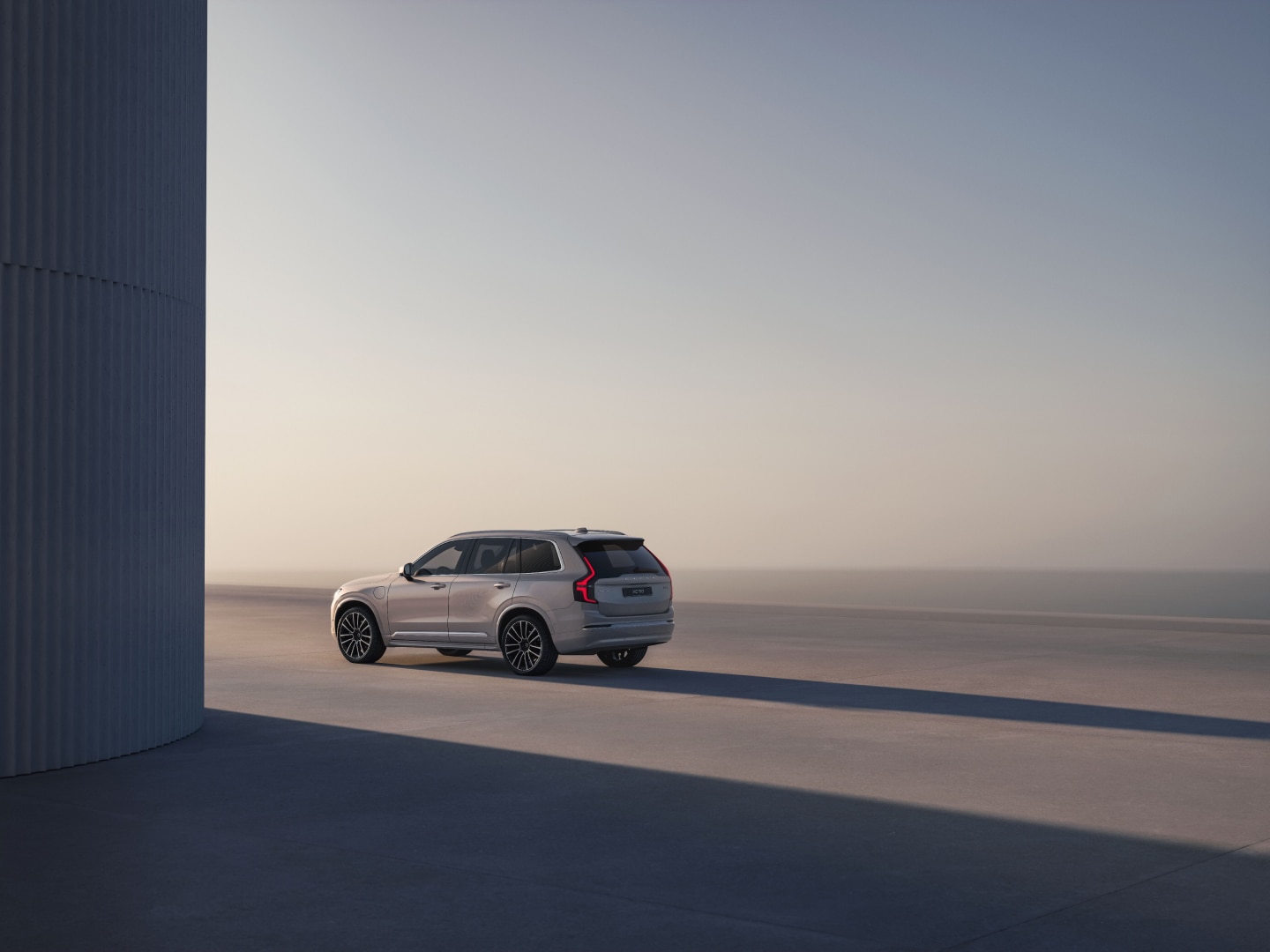 A side rear view of the XC90 plug-in hybrid 7-seater SUV.