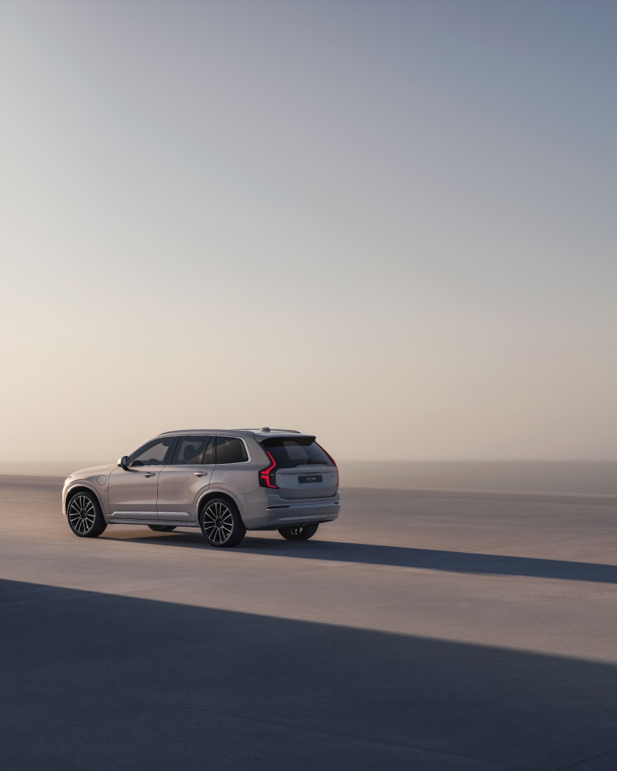 A side rear view of the XC90 plug-in hybrid 7-seater SUV.