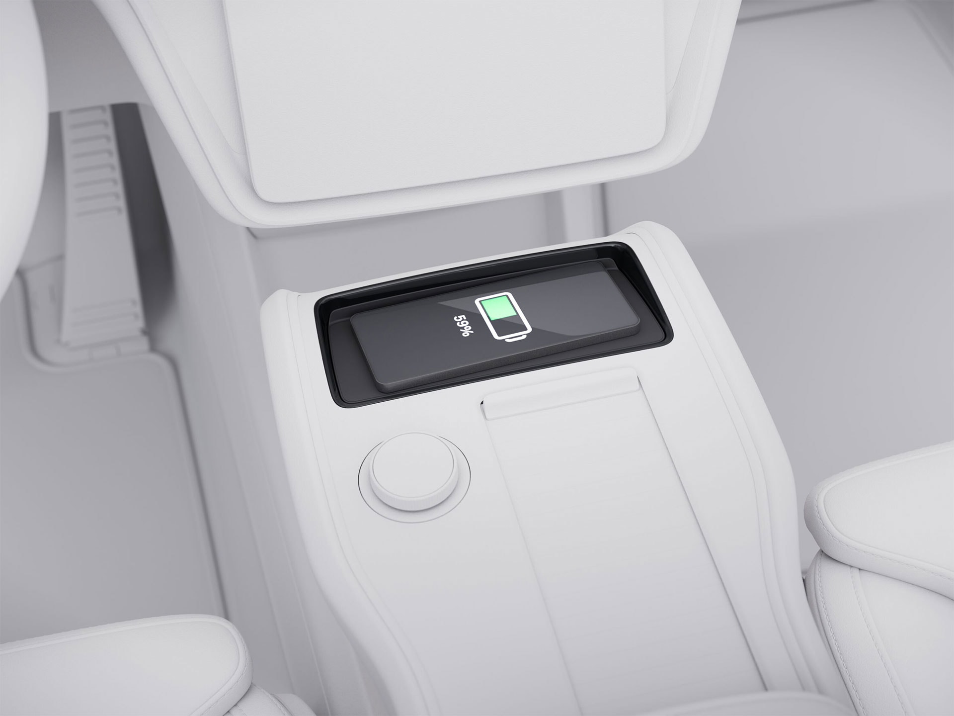 Console centrale du Volvo EX90 et focus sur un smartphone en charge sur le socle de recharge sans fil.