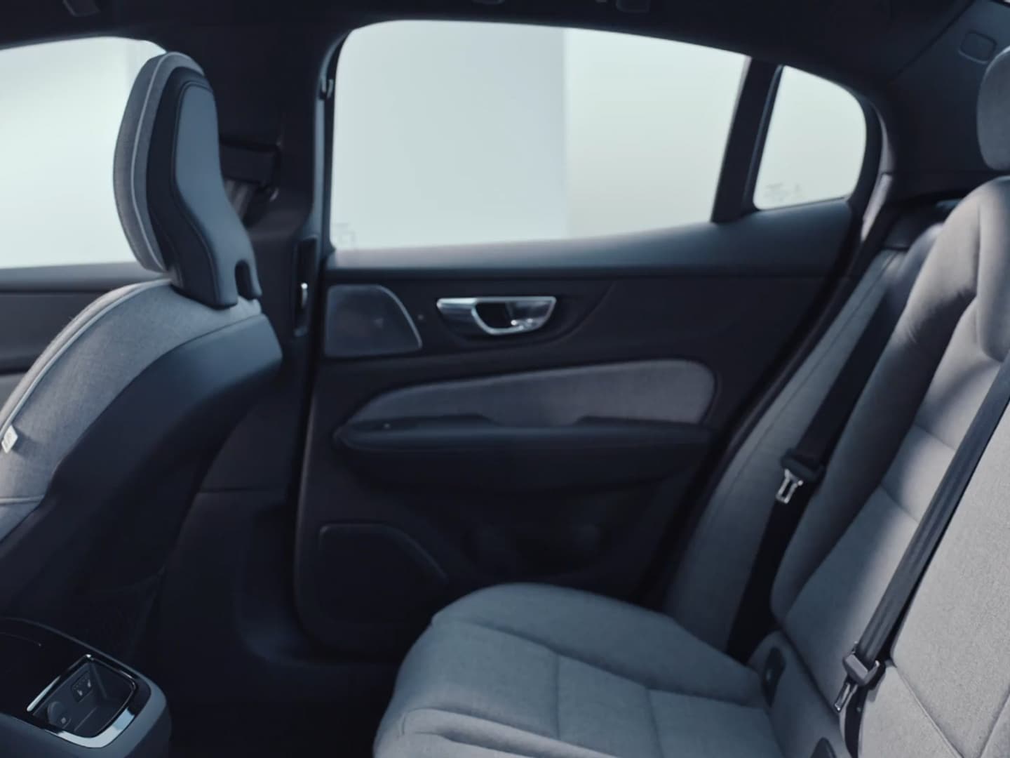 The Volvo S60 Recharge plug-in hybrid’s textile upholstered split-folding back passenger seats and rear centre console.