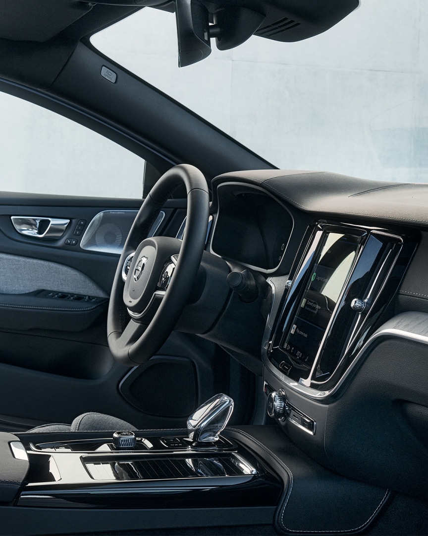 Volvo plug-in hybrid interior driver’s seat with steering wheel, infotainment screen, crystal gear shifter and driver’s seat door