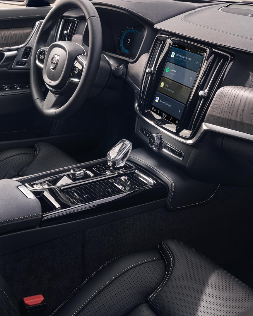 Interior view of the driver's seat, steering wheel and touchscreen centre display from the inside of a Volvo S90.