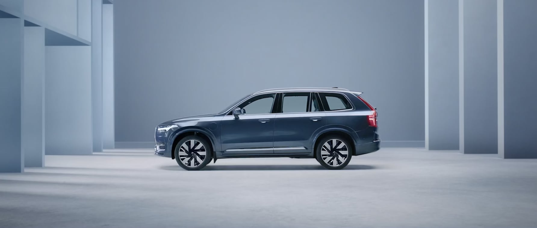 The side profile of a Volvo XC90 plug-in hybrid SUV.