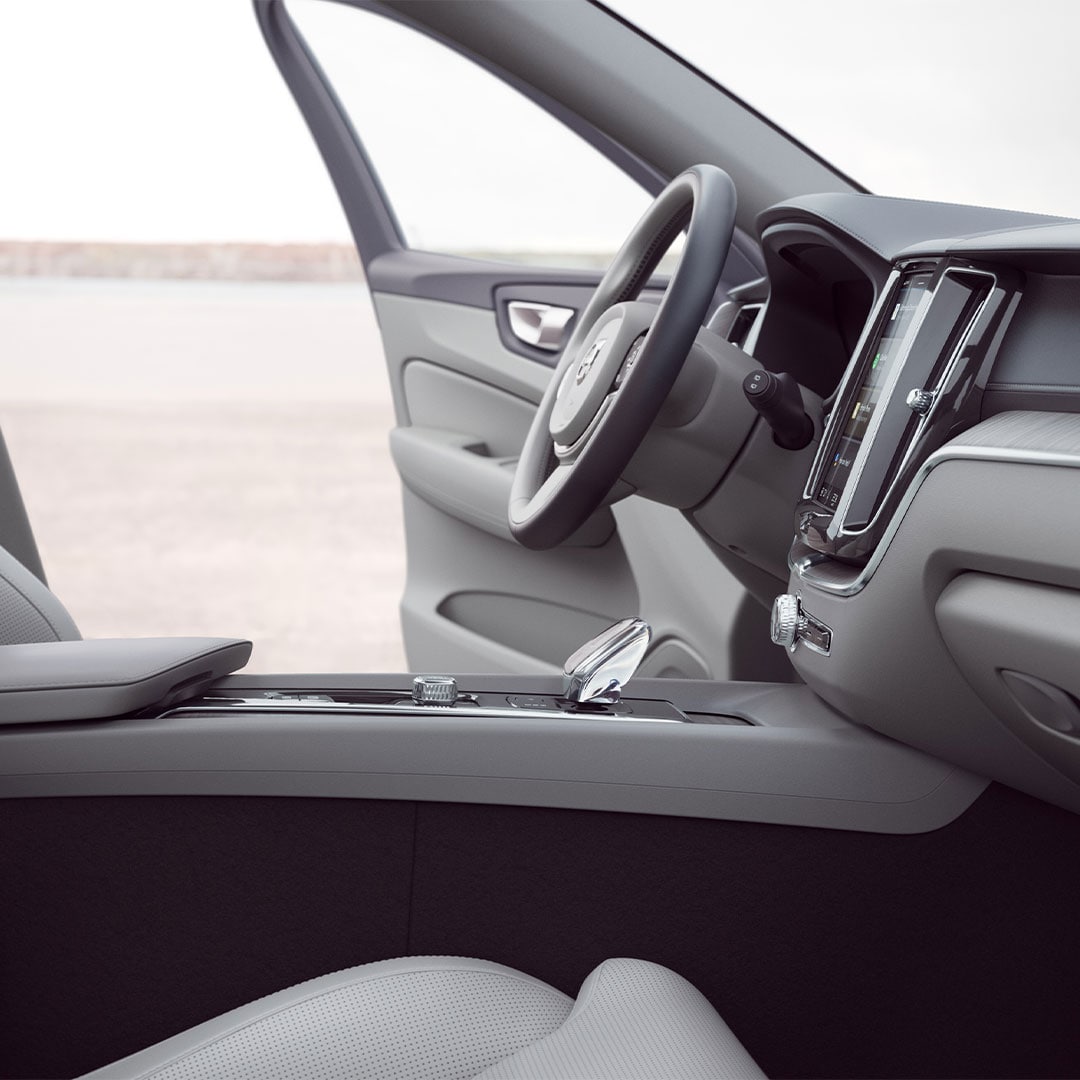 Front interior of Volvo XC60 with driver door open.