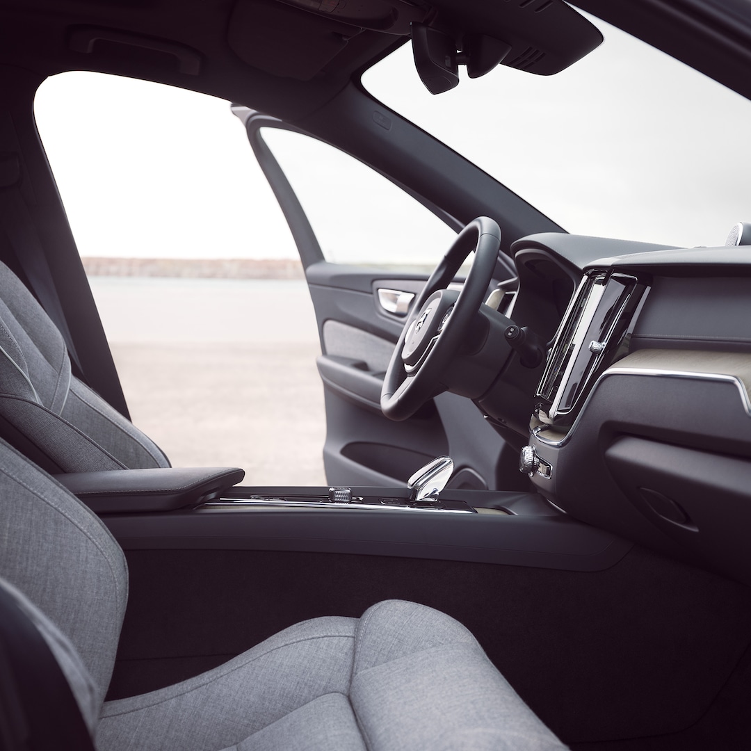 Front interior of Volvo XC60 Recharge with driver door open.