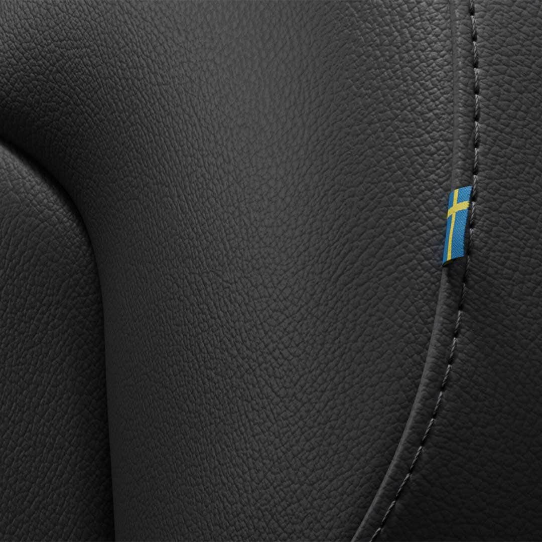 Close-up of the stitching on the Volvo S60 mild hybrid’s front passenger seat featuring a tiny Swedish flag. 