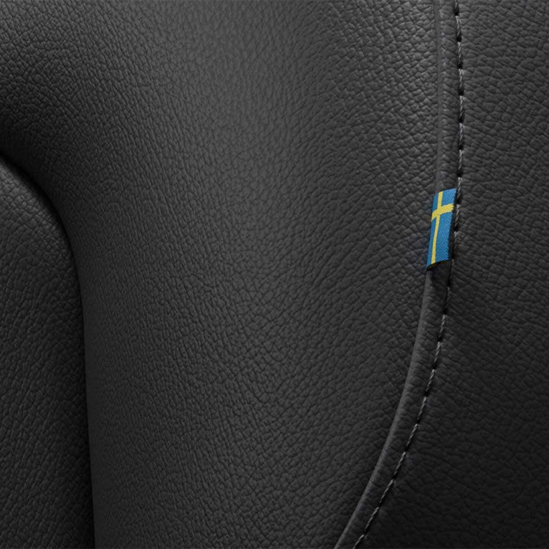 Close-up of the stitching on the Volvo S60 mild hybrid’s front passenger seat featuring a tiny Swedish flag. 