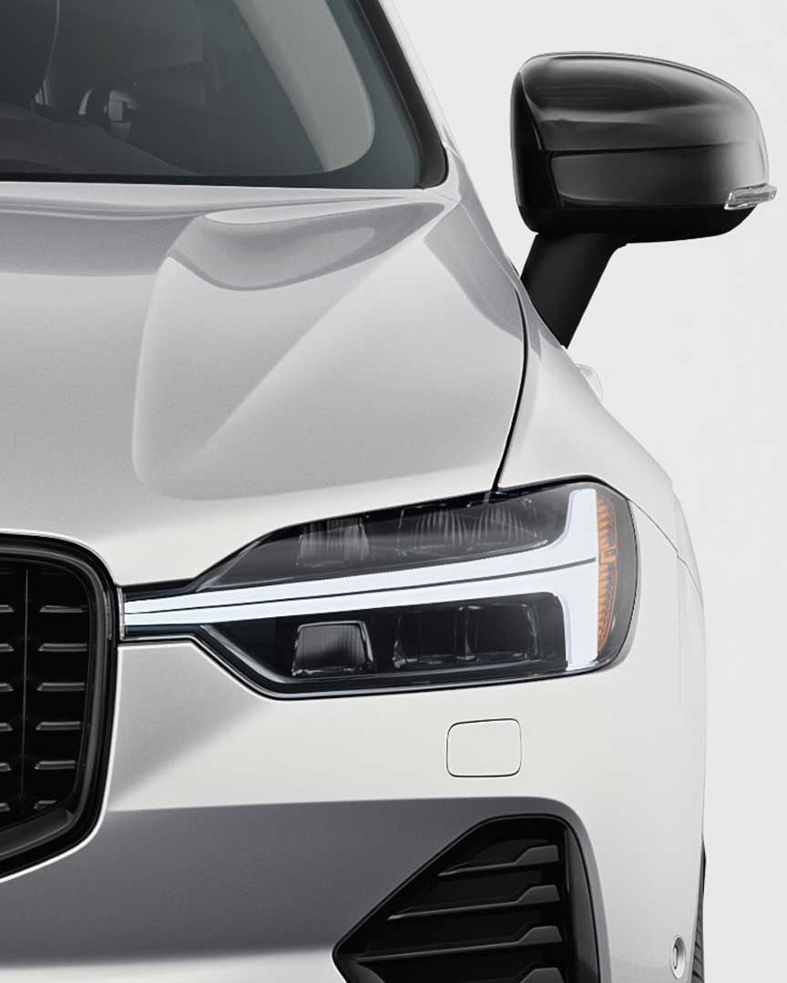 Front exterior of Volvo XC60 plug-in hybrid with the iconic front grille and headlamp design.