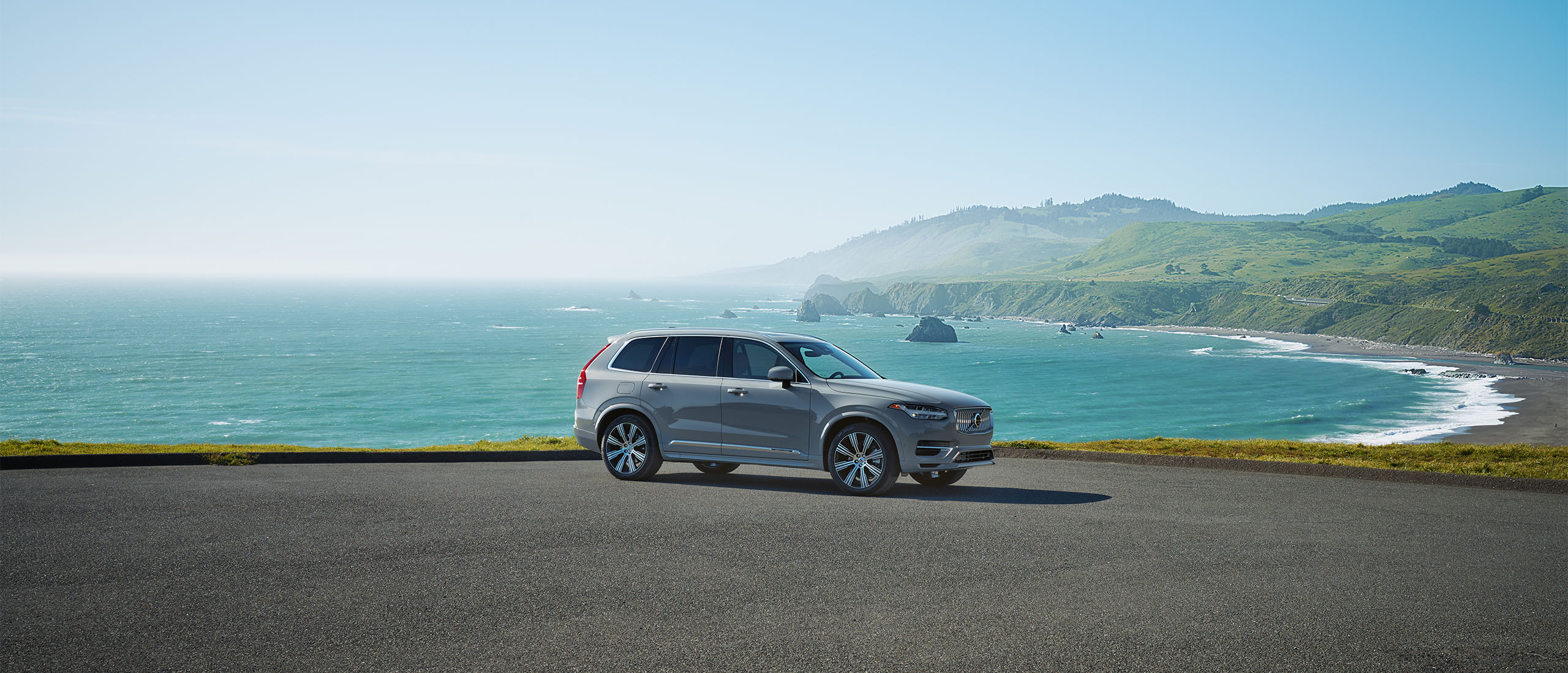 Volvo Offers - Summer Safely Saving Event  - XC90 plug-in hybrid SUV parked at beach  