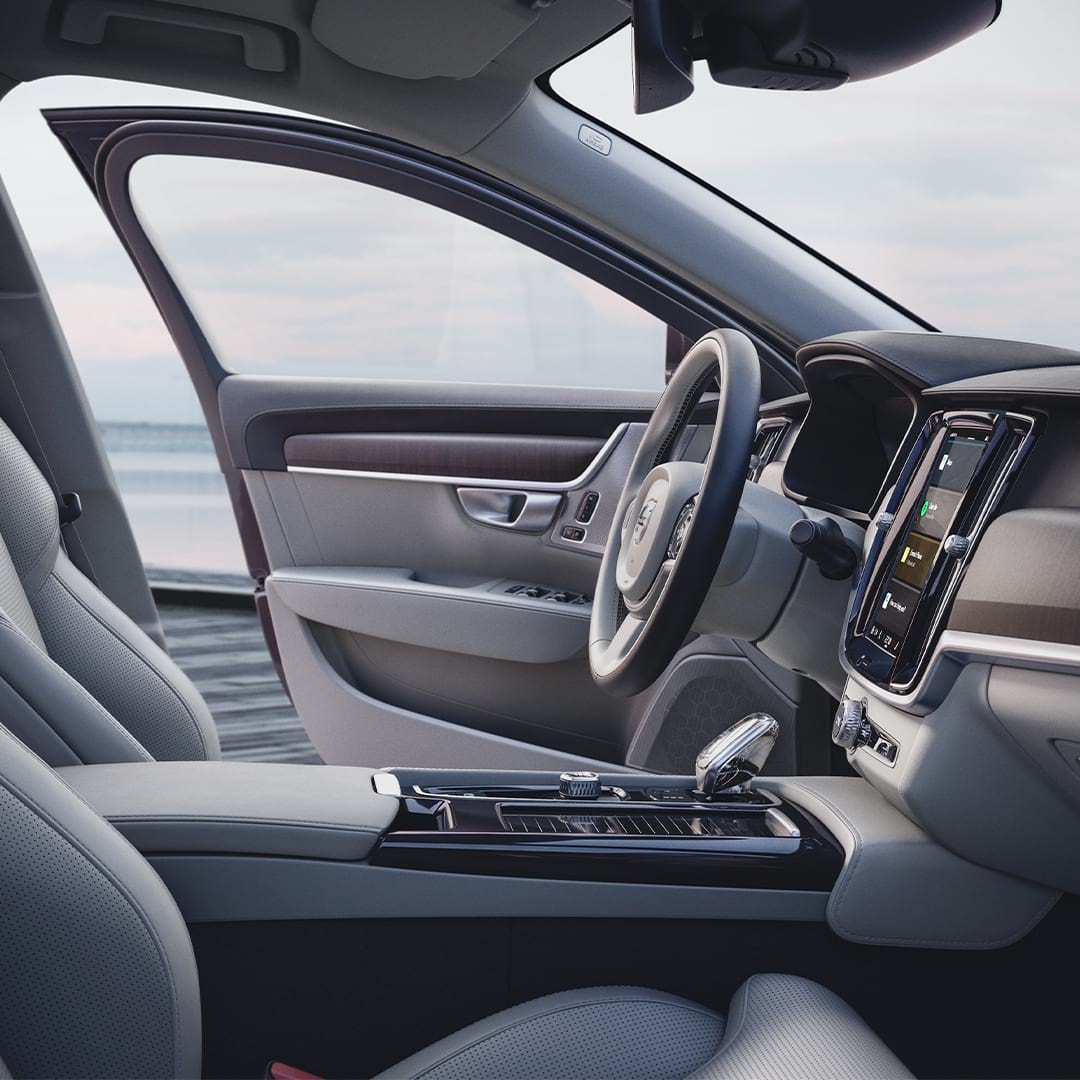 Inside of a Volvo S90 with light beige interior.